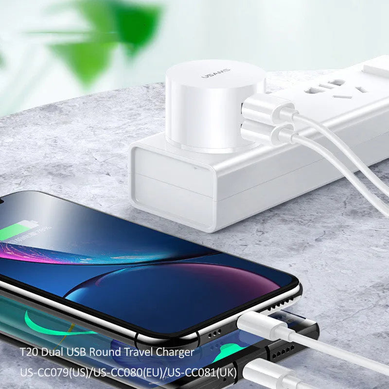 White portable universal dual USB phone charger with foldable US, EU, and UK plugs showing 39mm diameter