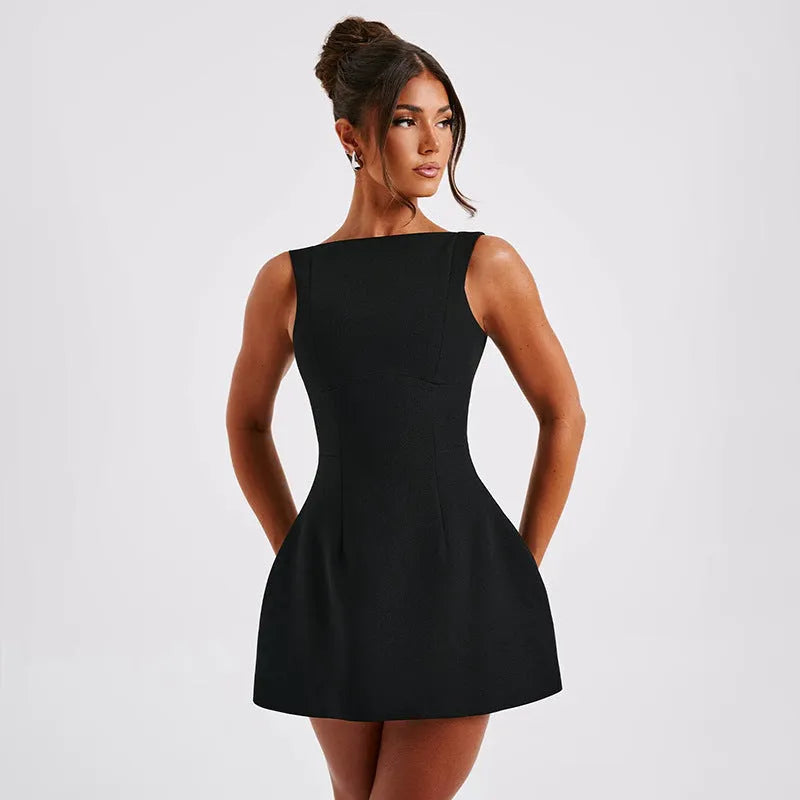 A woman wearing a slim-fitting black backless sleeveless dress with a high waist and short skirt.