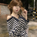 Dark blue women's oversized long-sleeve T-shirt with embroidered stripes and button details.