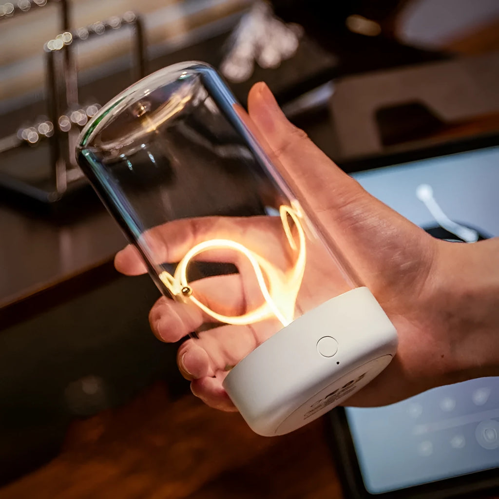 USB rechargeable LED camping light with a clear cover and bendable filament on an ABS base.