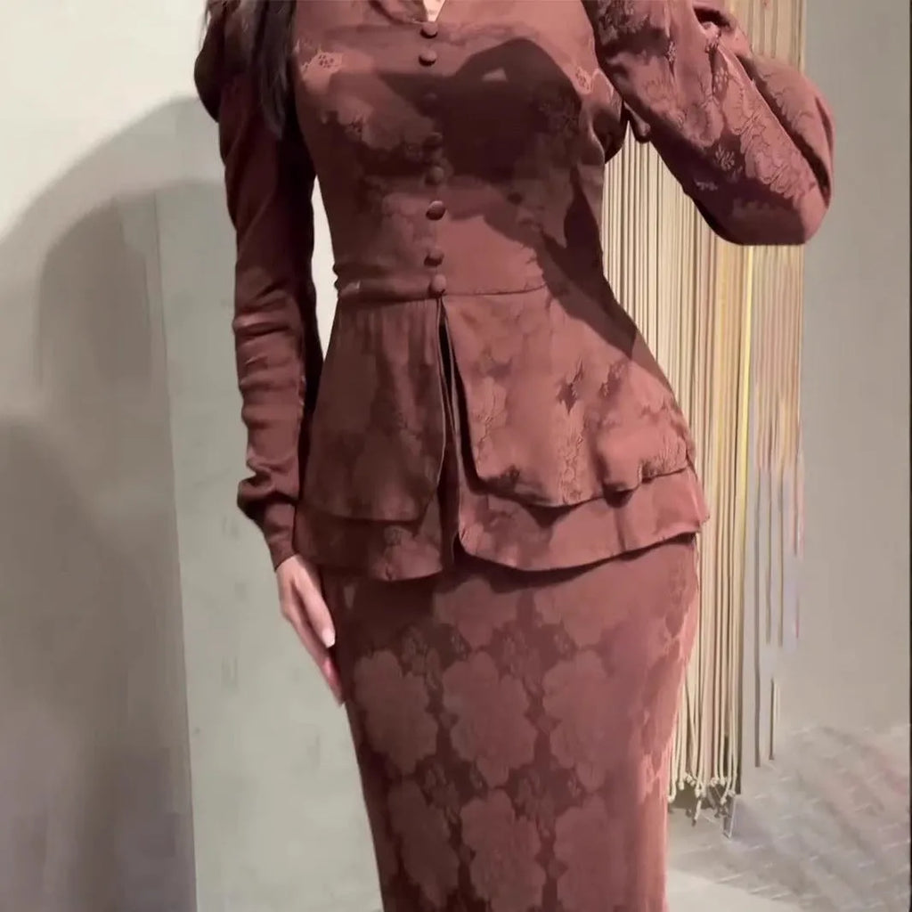 Dark brown retro dress with floral print, long sleeves, and button detailing on hanger