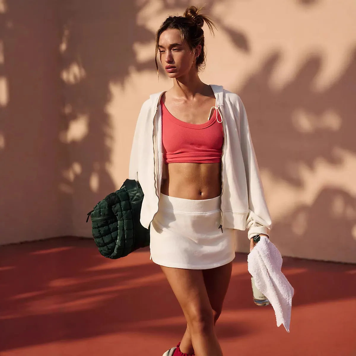 Women's grey hooded jacket and matching skirt co-ord set on a hanger.