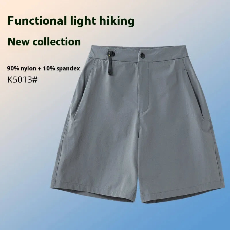 Man wearing khaki 3D cut athletic shorts with four-way stretch, suitable for running or climbing.