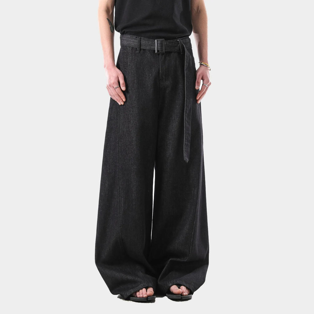 Black high-waist straight-leg jeans with gold contrast stitching on a flat lay.