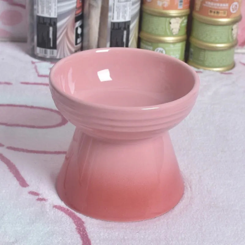 White ceramic pet bowl with a high foot base and wide, shallow eating area for dogs and cats