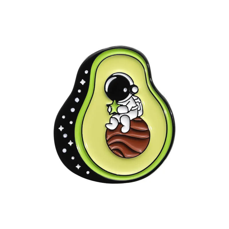 Colourful cartoon-style fruit metal brooch with pin back on a denim jacket lapel.