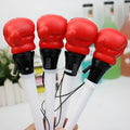 Set of four black creative pressure relief pens with boxing figure press-to-eject mechanism.