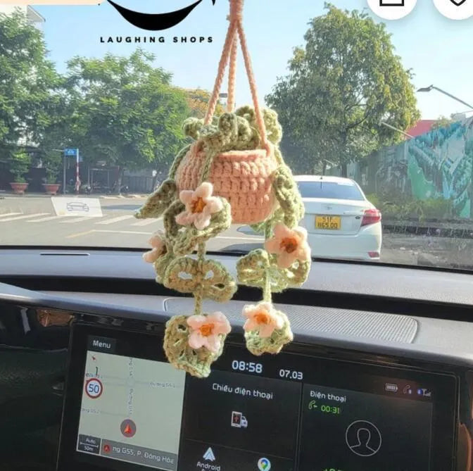 Green and white knitted wool car plant decoration with basin base and hanging rope
