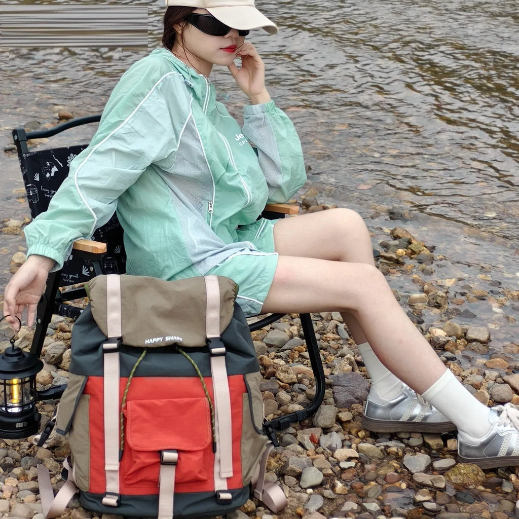 Orange green contrast colour outdoor backpack with multiple compartments and air cushion belt system.