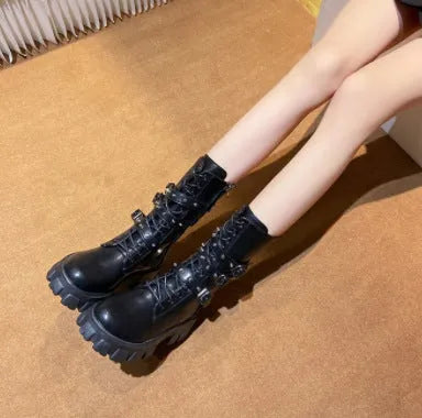 Black women's mid-calf knight boots with metal buckle detail and side zip on a white background