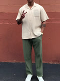 Men's green pleated casual trousers in polyester fabric showing ankle-length design and regular fit