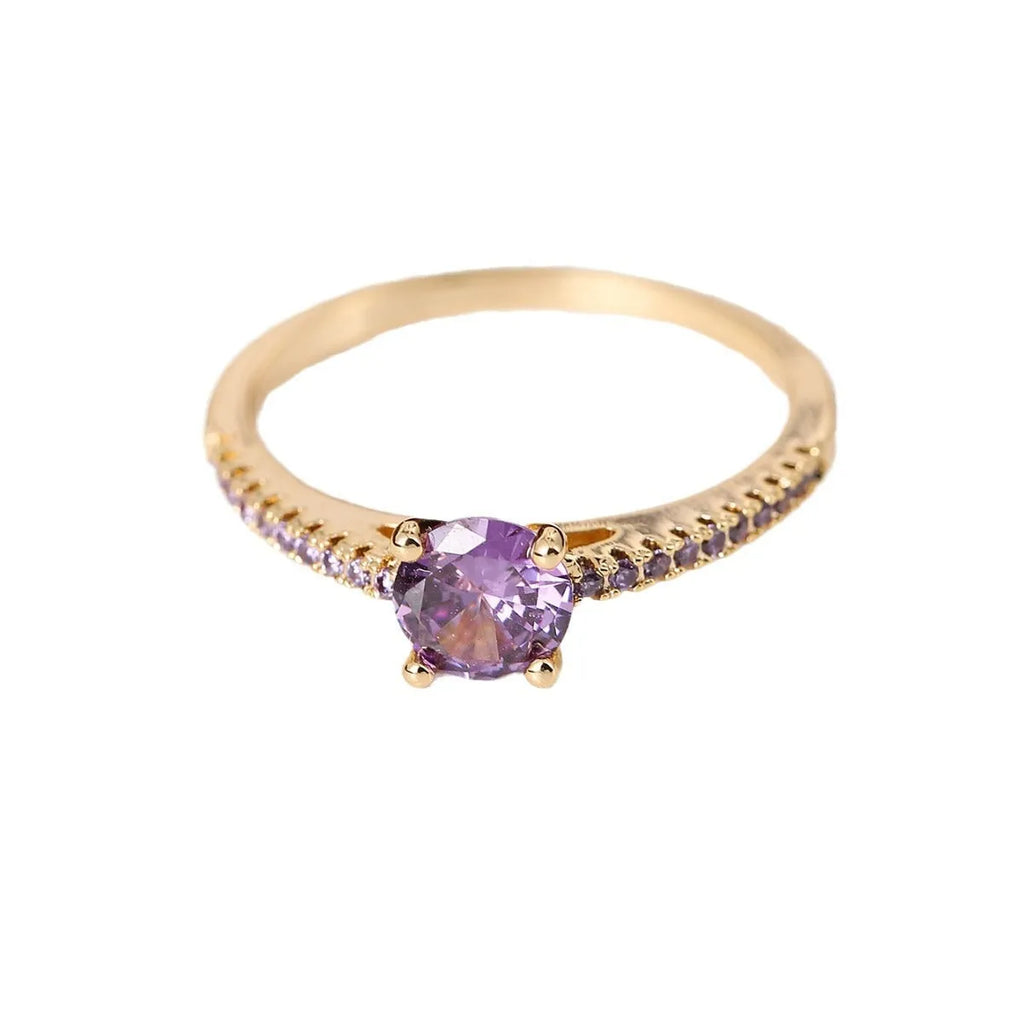 Geometric hexagon fashion ring in solid copper with an electroplated gun black purple finish, shown on a finger.