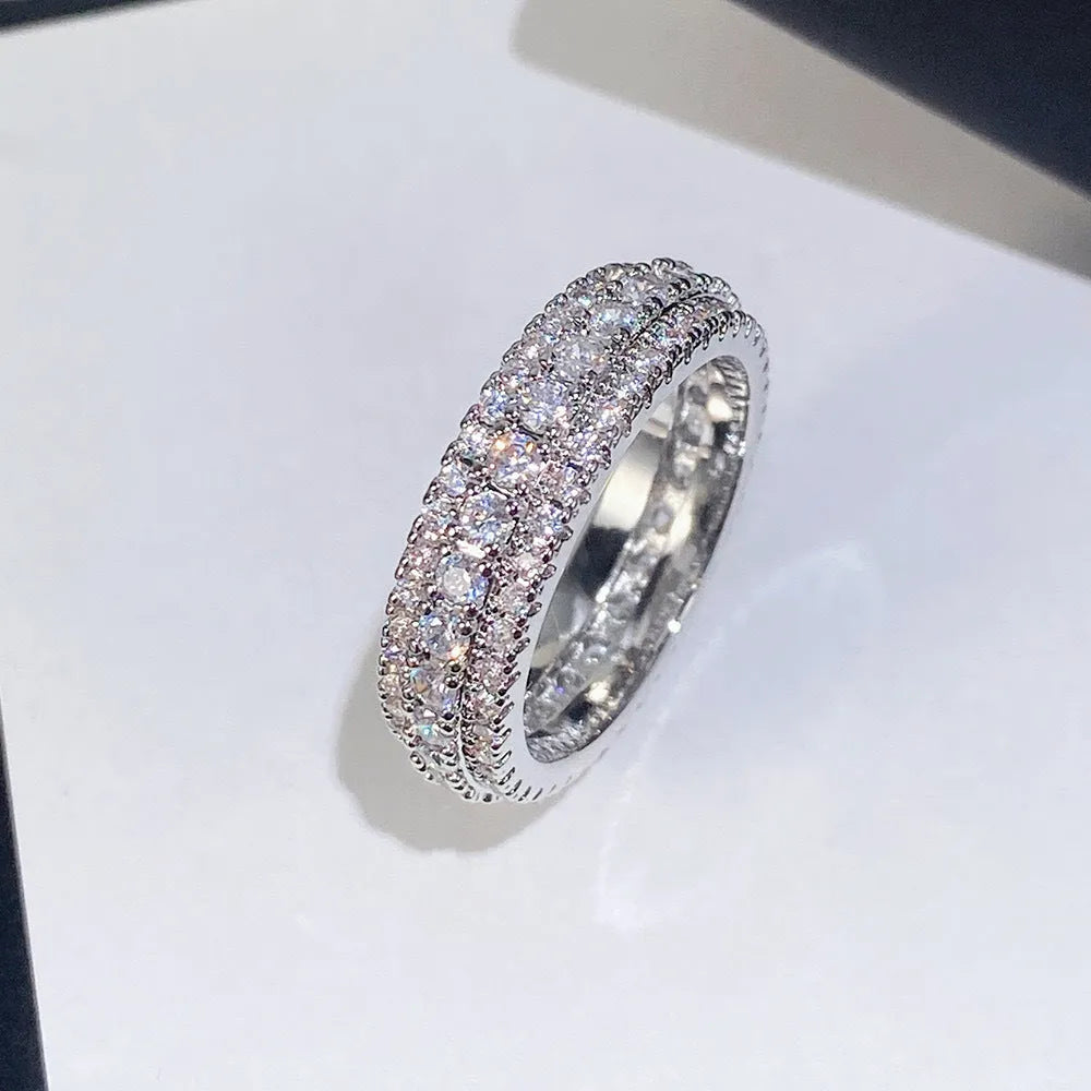 Geometric triangle personalised engagement ring with zircon inlay on copper, shown in a choice of finishes.