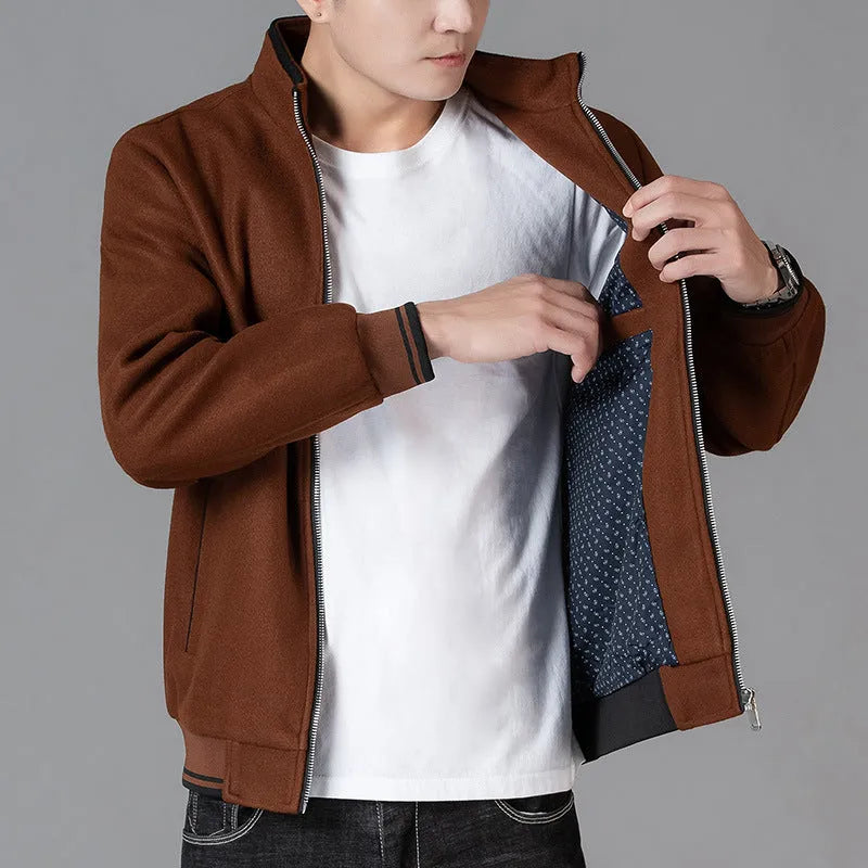Men's grey polyester fleece sports coat with long sleeves and side pockets.