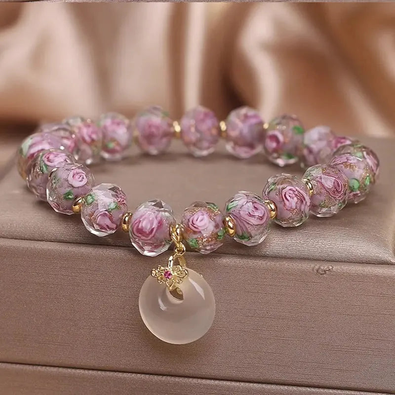 Purple glass flower amethyst bracelet with peace buckle on white background