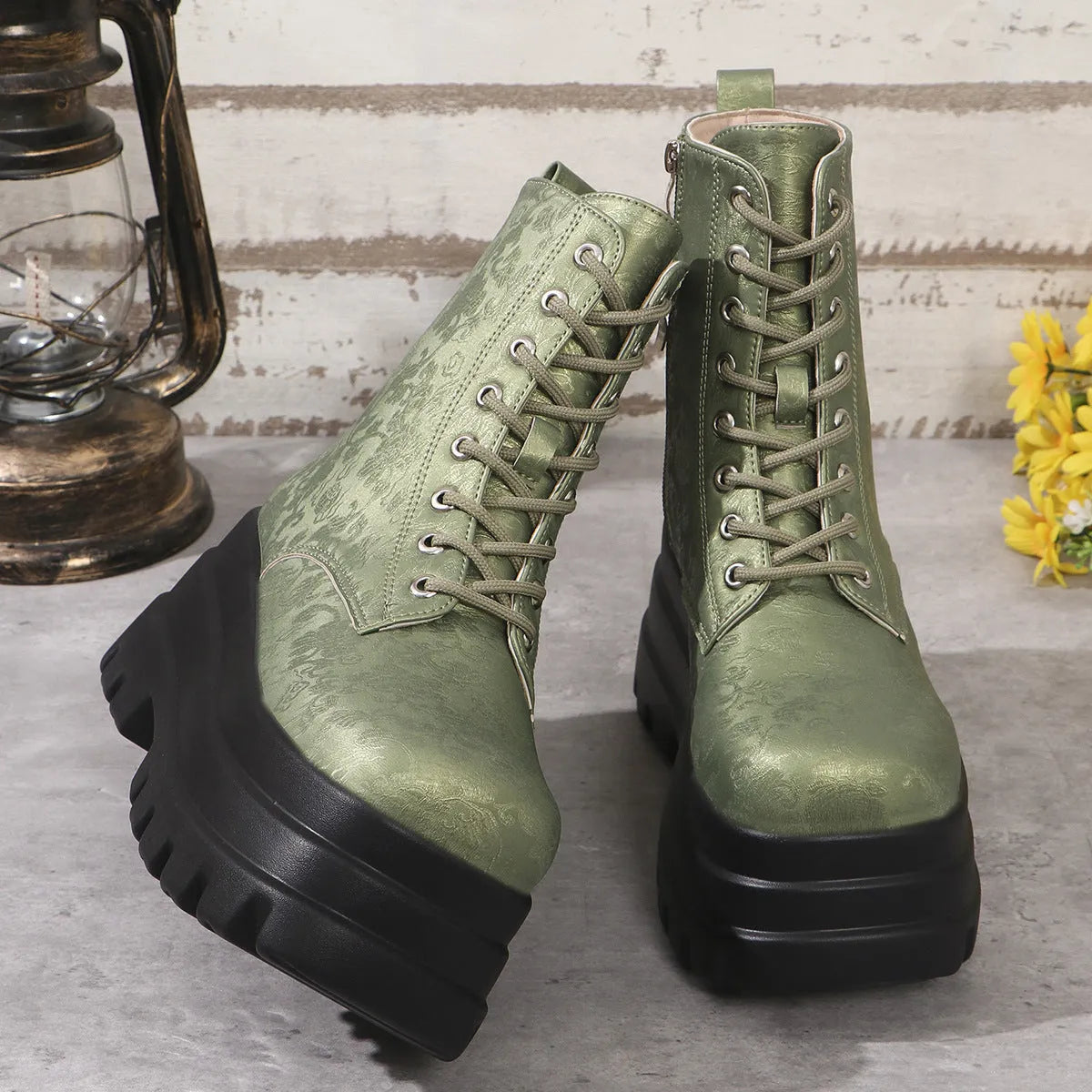 Women's black retro platform Martin boots with patchwork detail and side zipper.
