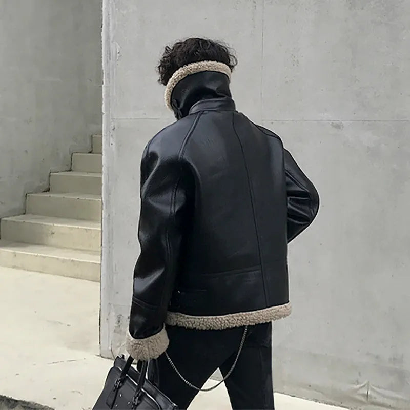Men's black PU leather jacket with padded collar, front zip, and long sleeves on a model