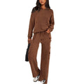 Women's long sleeve polyester sports suit and trousers set in multiple colour options on a hanger.