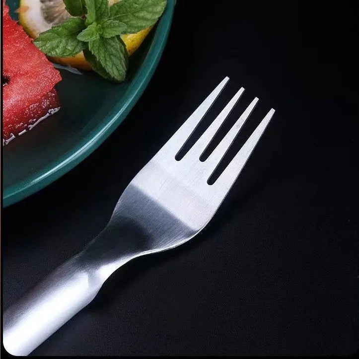 Stainless steel watermelon slicer and fork tool on a kitchen counter