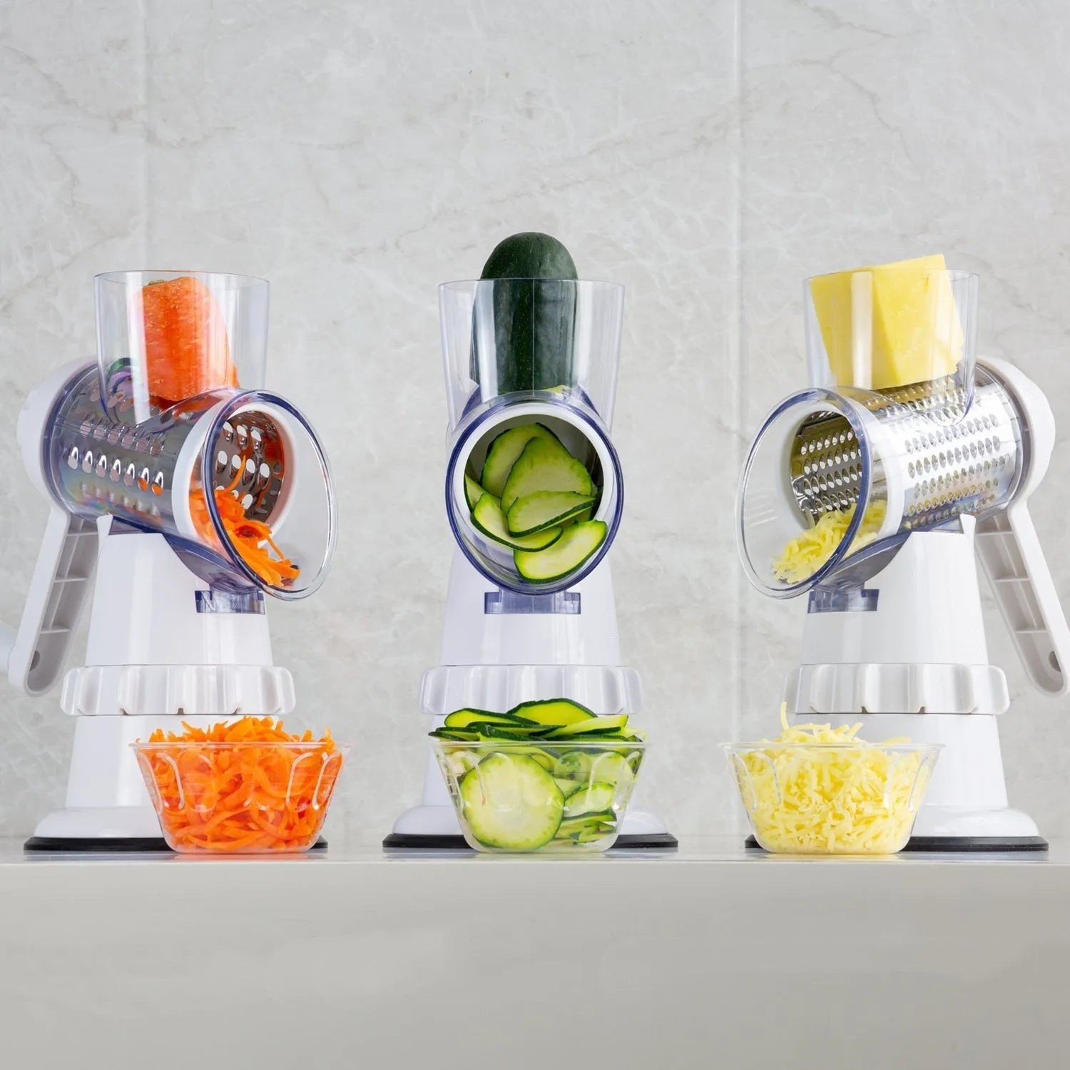 White plastic 3-in-1 manual vegetable slicer with suction feet and stainless steel blades