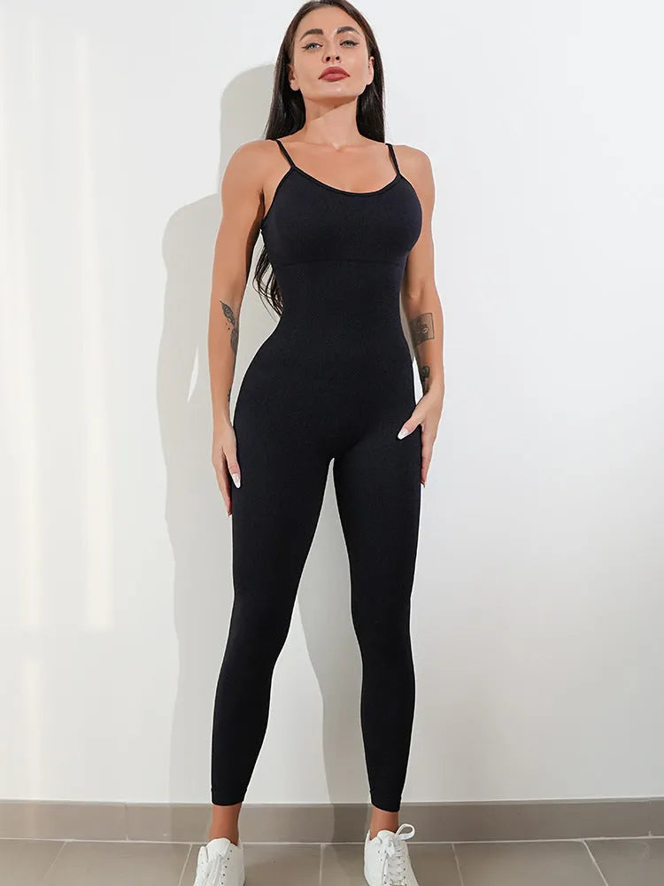 Women's black sleeveless unitard jumpsuit with spaghetti straps and a tight fit.