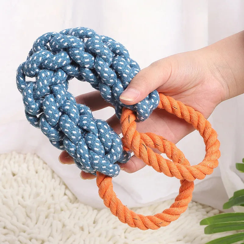 Blue braided cotton rope dog toy shaped like a bone with two rings, on a white background.