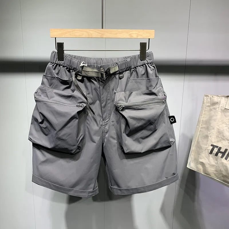 Men's black loose-fitting work shorts with elastic waistband and pockets, laid flat