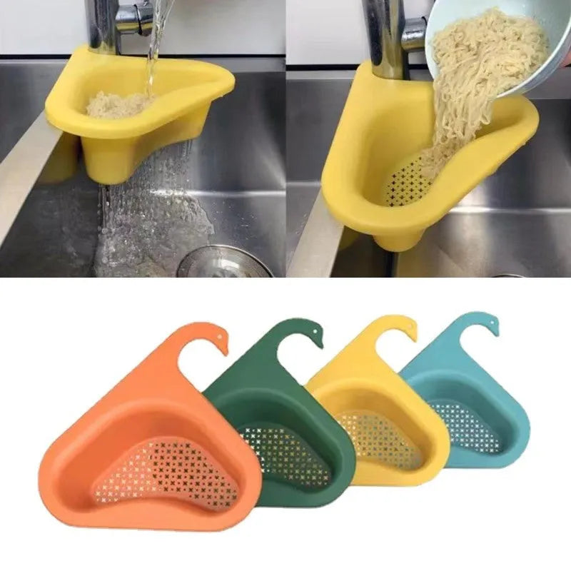 Blue plastic swan-shaped basket hanging over a kitchen sink edge to drain fruit and vegetables.