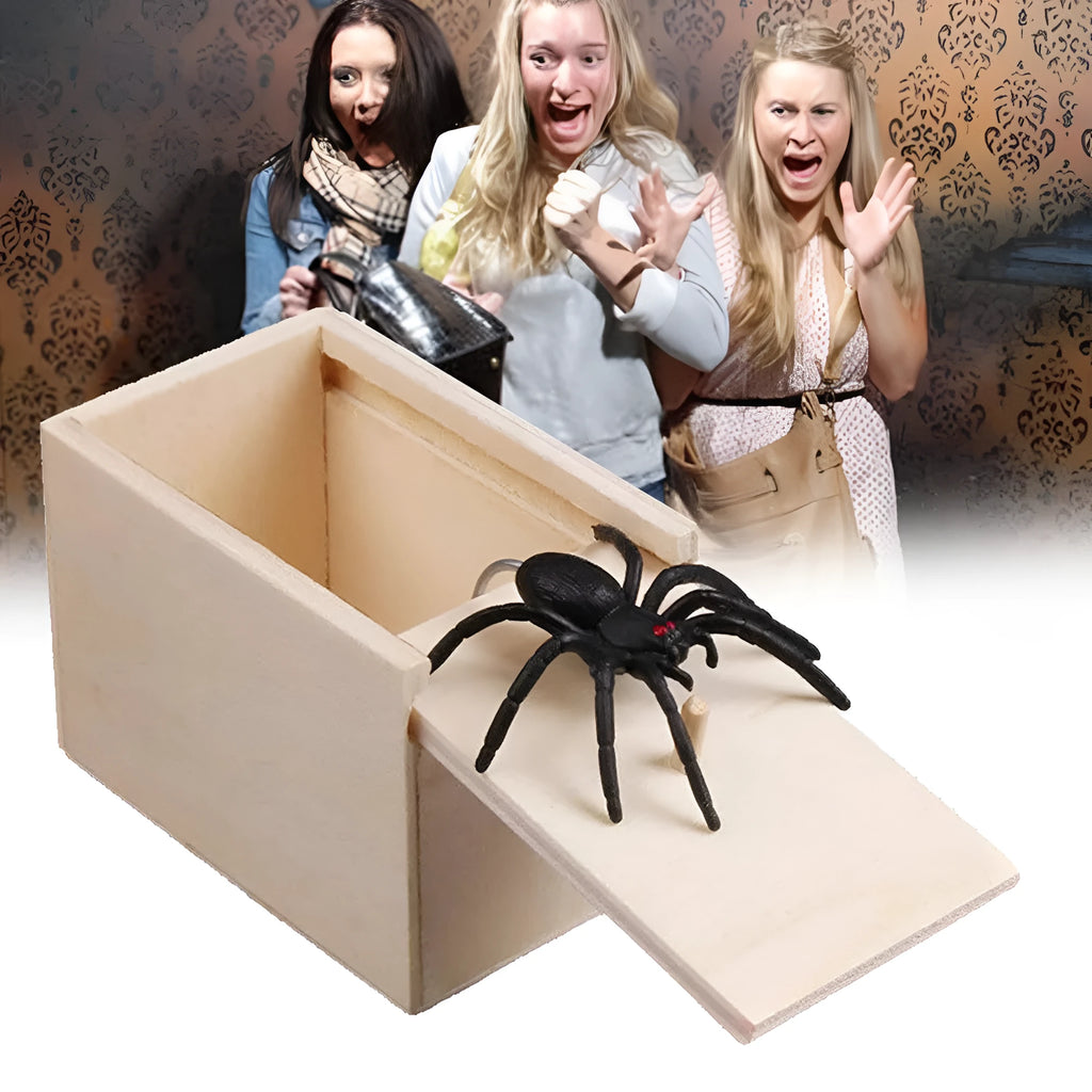 Wooden prank scare box closed, with a lifelike jumping spider toy next to it.