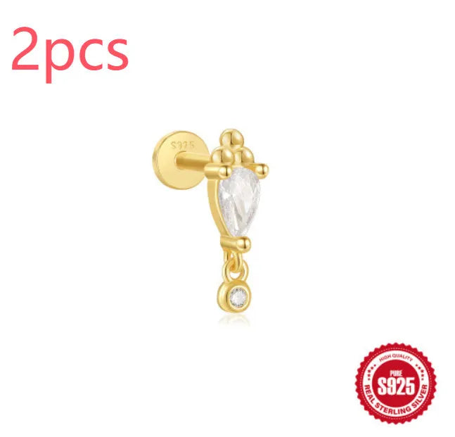 S925 sterling silver ear stud with XINGX inlaid tassel design in a gold colour.
