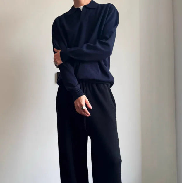 Milky white pure wool lapel collar polo sweater laid flat, showing loose fit and long sleeves.