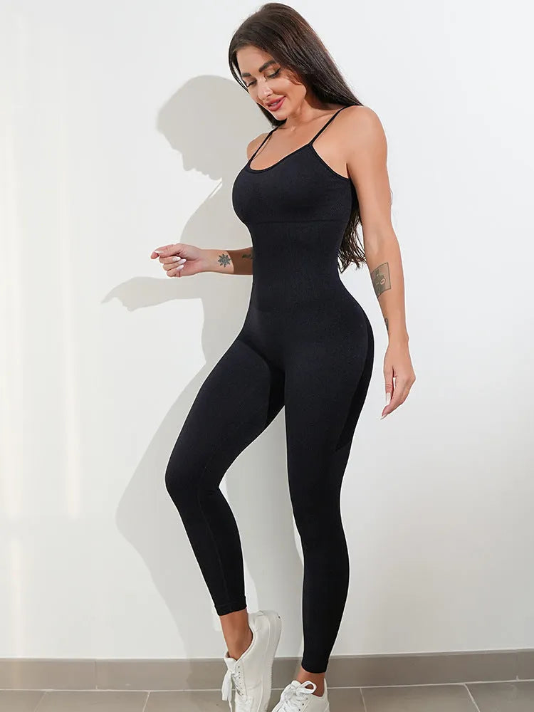 Women's black sleeveless unitard jumpsuit with spaghetti straps and a tight fit.