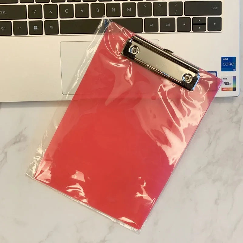 Transparent A4 writing board pad with metal clip holding paper, shown in blue colour option