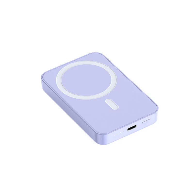 Pink magnetic wireless power bank on a table showing its compact size and charging surface.