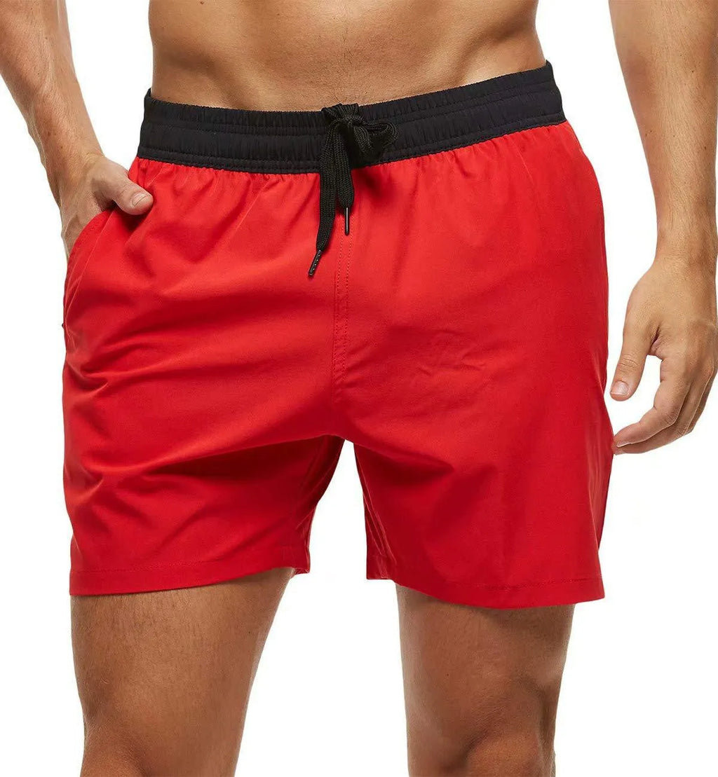 Men's blue training shorts with stitching waist detail, zippered pockets, and an included grey headband.