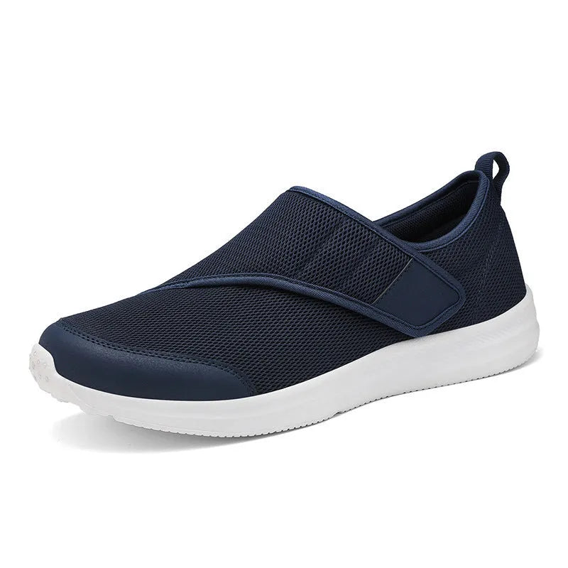 A pair of casual walking shoes with a mesh upper and Velcro strap closure, shown in one of four available colours.