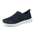 A pair of casual walking shoes with a mesh upper and Velcro strap closure, shown in one of four available colours.