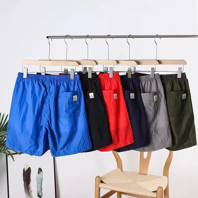 Men's thin quick-drying polyester sports shorts in straight leg style, shown in army green colour.