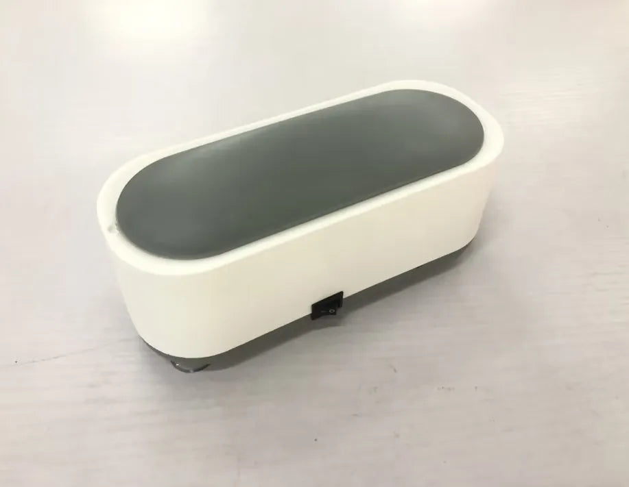 Off-white ultrasonic cleaning machine with stainless steel tank for jewellery and glasses.