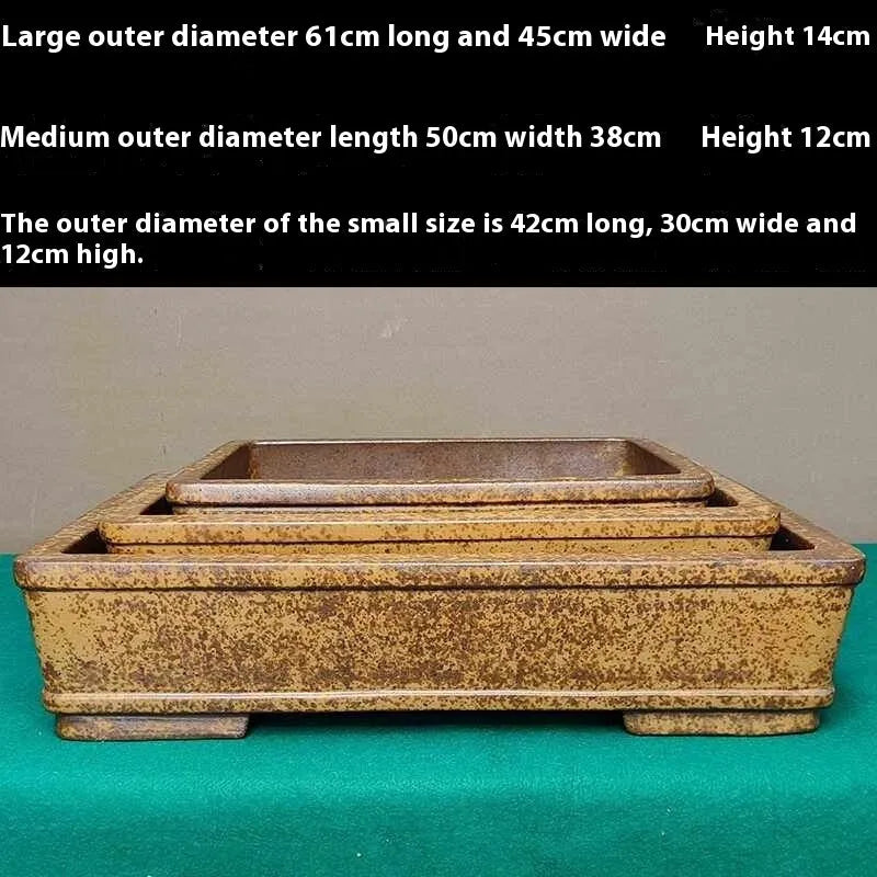 Straight-sided shallow rectangular Yixing purple Zisha clay flowerpot on a wooden surface.