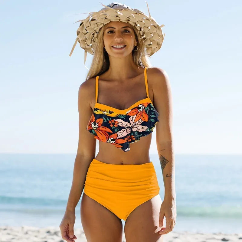 Women's blue polyester swimsuit with bikini top and high-waist pleated pants.