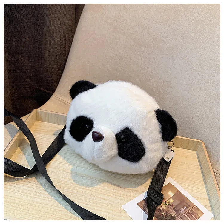 Soft plush cylindrical crossbody bag in panda head design with a sandwich pocket.