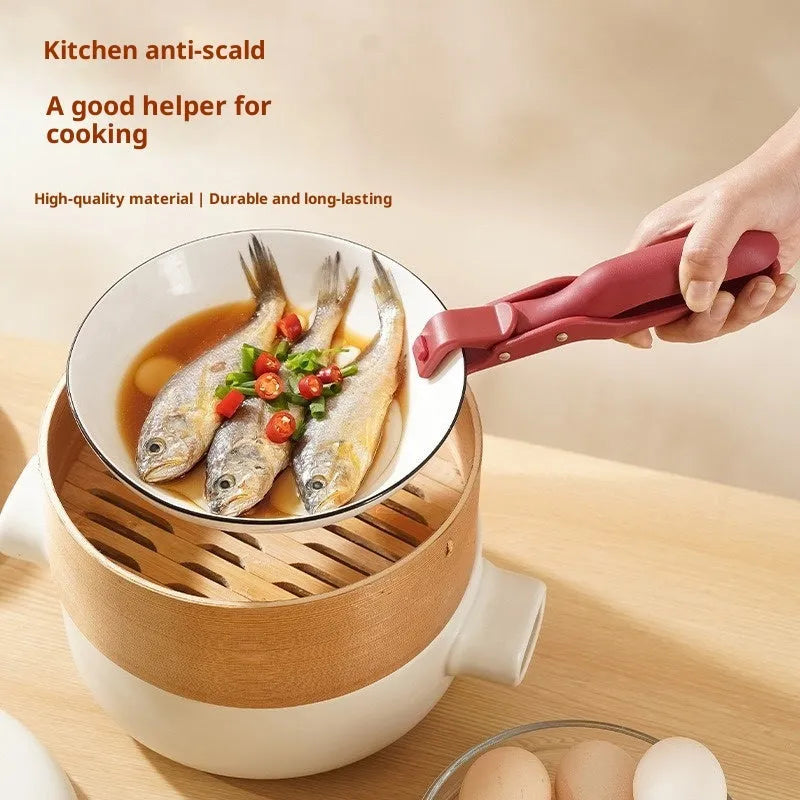 Creative household kitchen silicone anti-scalding clip in carmine colour on a table with a nearby pot