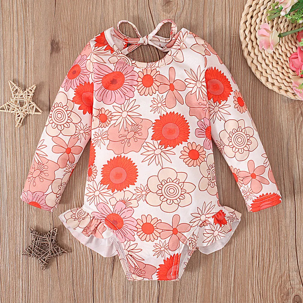 Girl's white floral print one-piece swimsuit with crew neck and open back design