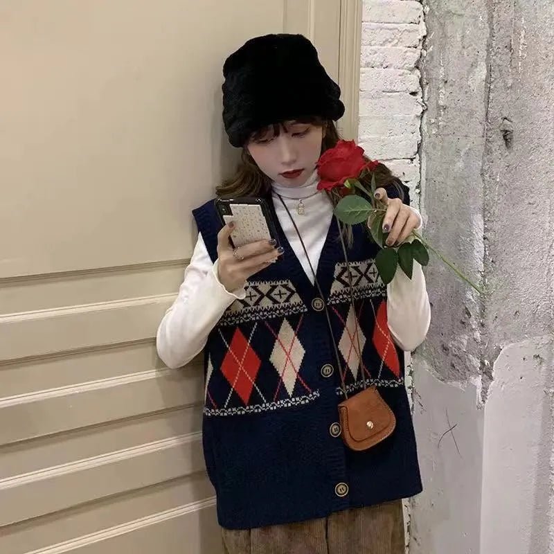 Khaki sleeveless loose cardigan top with diamond plaid pattern, open front.