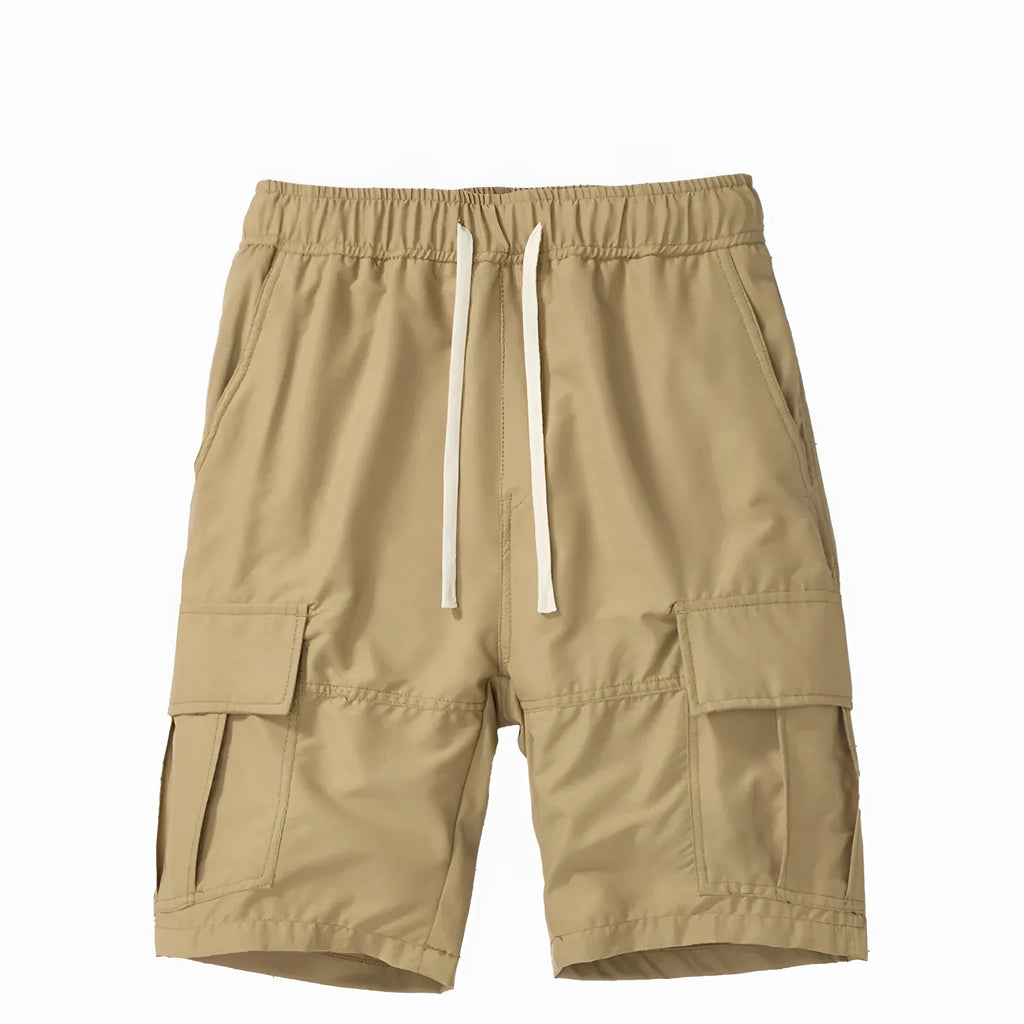 Man modelling loose fit cropped trousers with multiple pockets in a khaki colour.
