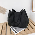 Women's solid colour canvas handbag showing horizontal square shape with double shoulder straps