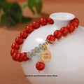 Women's handmade cinnabar bracelet with fu character charm, jade spacer beads, and red sand tassel detail