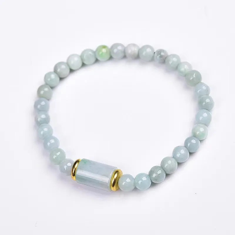 A close-up of a round Myanmar ice jade bead bracelet in emerald colour.