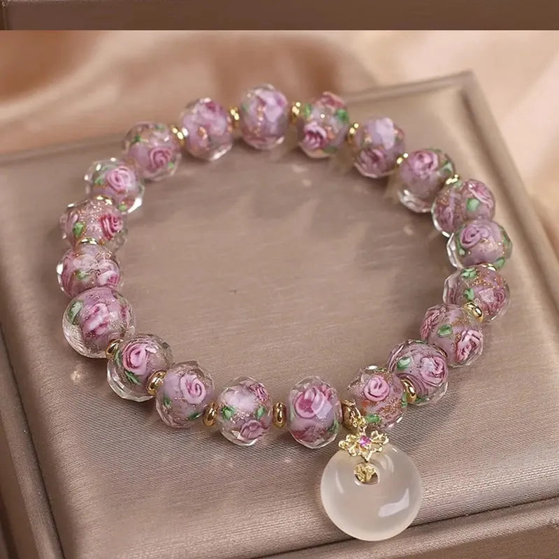 Purple glass flower amethyst bracelet with peace buckle on white background